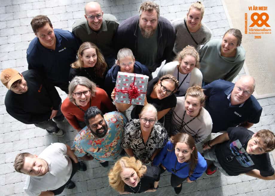 Flera medarbetare håller upp en julklapp
